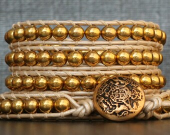 wrap bracelet- gold plated metal beads on pearl white leather