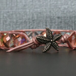May include: A pink leather bracelet with iridescent glass beads and a silver starfish charm.