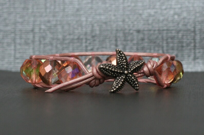 May include: A pink leather bracelet with iridescent glass beads and a silver starfish charm.