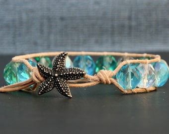 May include: A brown leather bracelet with blue and clear glass beads and a silver starfish charm.