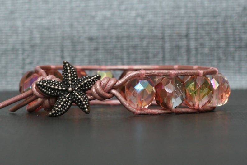 May include: A pink leather bracelet with iridescent glass beads and a silver starfish charm.
