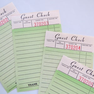 May include: Four blank guest checks with green lines and the text "Guest Check" printed at the top. The check numbers are 370202, 370203, 370204, and 370205.
