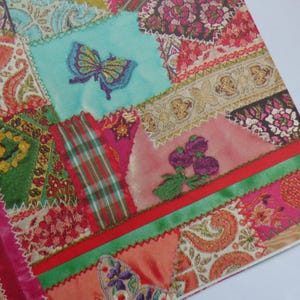 May include: A colorful patchwork design featuring various fabric patterns and textures. The design includes a turquoise square with a butterfly, plaid, floral, and paisley elements. The edges are stitched with a zigzag pattern, and the overall color scheme is vibrant.