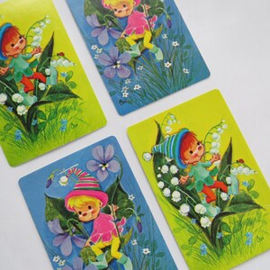 May include: A white ceramic mug with a black handle and the text "But First, Coffee" in a black, bold font. The mug is on a white surface.