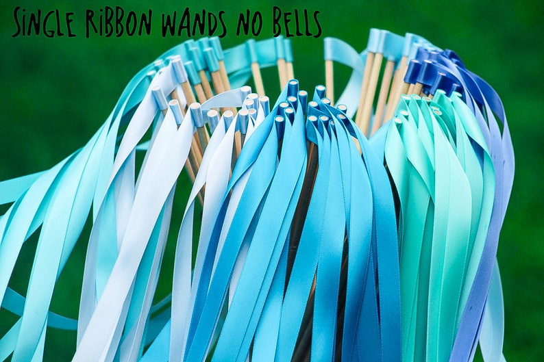 May include: A bunch of blue and light blue ribbon wands with wooden sticks and silver tips. The text "SINGLE RIBBON WANDS NO BELLS" is at the top of the image.