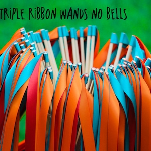 May include: A bunch of triple ribbon wands with orange, red, and blue ribbons. The wands are made of wood and have no bells. The text "TRIPLE RIBBON WANDS NO BELLS" is written above the wands.