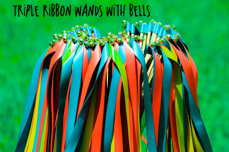 May include: A bunch of colorful ribbon wands with bells on the ends. The ribbons are red, blue, and yellow. The wands are made of wood and have a silver bell on the end of each ribbon.