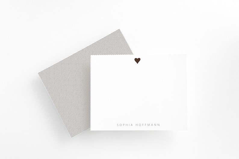 May include: White card with a small brown heart in the top right corner and the text "SOPHIA HOFFMANN" at the bottom.