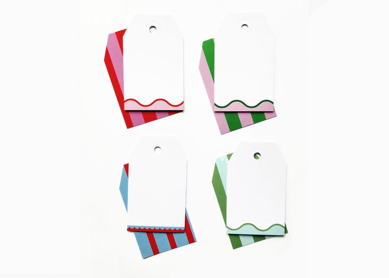 May include: Four white gift tags with scalloped edges and colorful striped accents. Each tag has a hole at the top for stringing. The striped accents are red, pink, blue, and green.