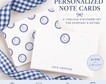 May include: White note cards featuring a blue rabbit emblem and the text JACK CHESTER. The set includes a card with a repeating rabbit pattern and a blue gingham ribbon. The cards are A2 size, measuring 10.8 cm by 14 cm.