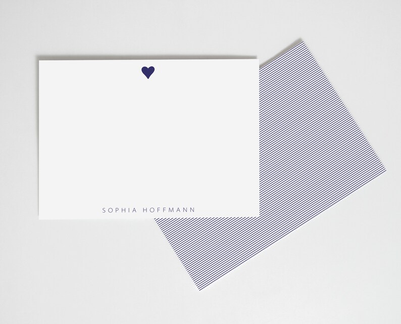May include: A white card with a navy blue heart and the text "SOPHIA HOFFMANN" printed at the bottom. The card is paired with a navy blue striped envelope.