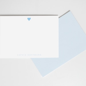 May include: A white card with a light blue heart and the text "SOPHIA HOFFMANN" printed in light blue.