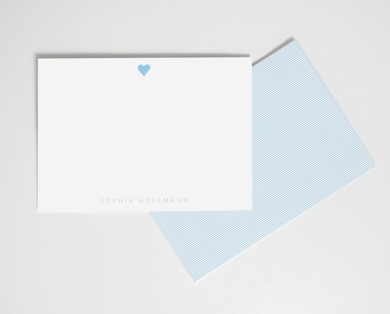 May include: A white card with a light blue heart and the text "SOPHIA HOFFMANN" printed in light blue.