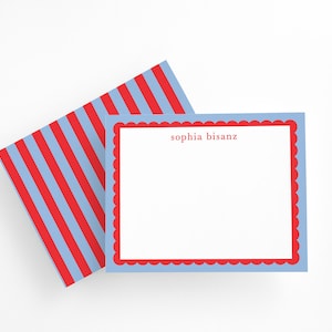 May include: A set of stationery featuring a light blue scalloped border with a red interior border. The text "sophia bisanz" is printed in red. The envelope has a red and light blue striped pattern.