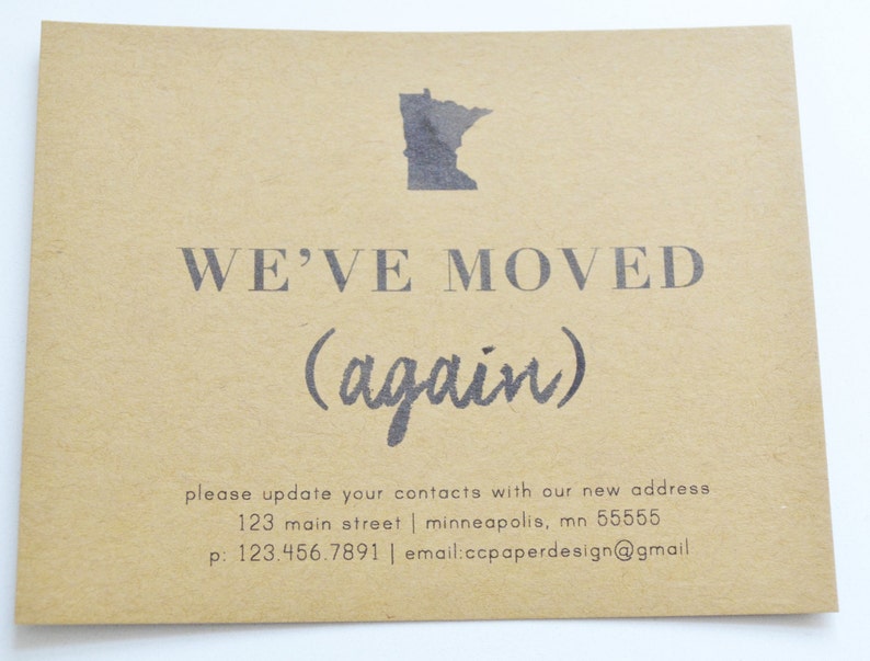 May include: A brown paper card with the text "WE'VE MOVED (again)" and a black outline of the state of Minnesota. The card also includes a new address, phone number, and email address.
