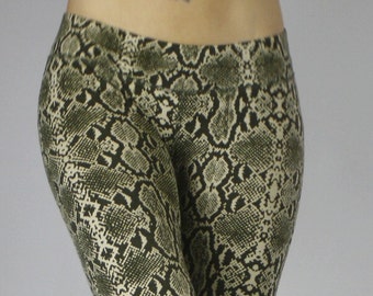 May include: A pair of black and white snake print leggings with a cropped length.