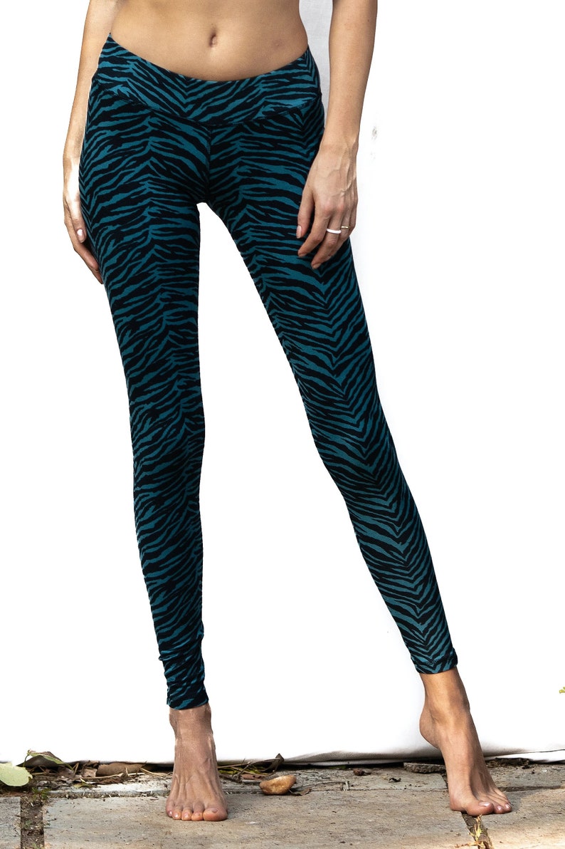 May include: Teal and black leggings with a zebra print pattern.