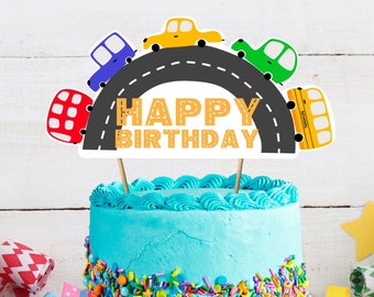 May include: A blue birthday cake with colorful sprinkles and a cake topper featuring a road with cars and the words "Happy Birthday".