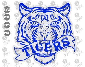 May include: A blue and white tiger head with a white banner that says "TIGERS" in blue letters. The tiger is snarling with its mouth open and teeth showing.