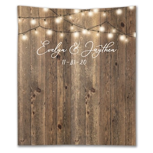 May include: Rustic wood backdrop with string lights and the text "Evelyn & Jaythen 11-31-20" in white.