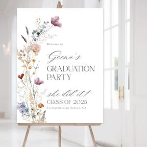 May include: A white sign with a floral border and the text "Welcome to Geena's Graduation Party she did it! Class of 2025 Lexington High School, MA"
