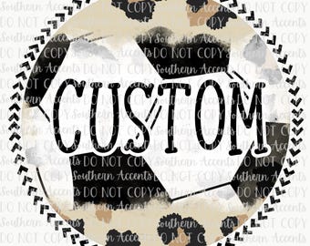 May include: A white soccer ball with black panels is surrounded by a brown and black leopard print pattern. The word "CUSTOM" is written in black across the center of the ball. The ball is surrounded by a black and white chevron border.