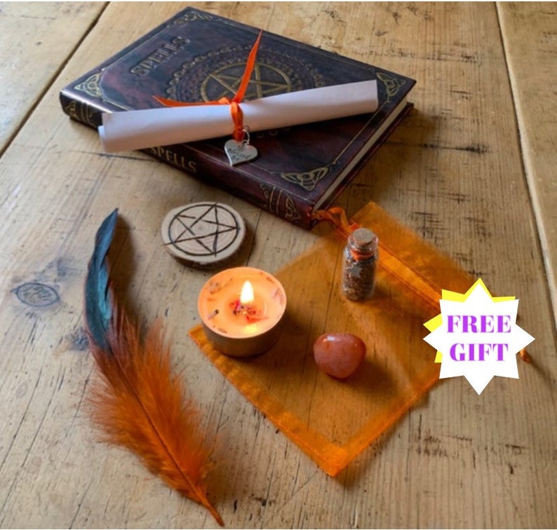 May include: A witchy spell kit with a book, candle, feather, wooden pentagram, and a small pouch with crystals. The book has the word "Spells" on the cover. The kit comes with a free gift.