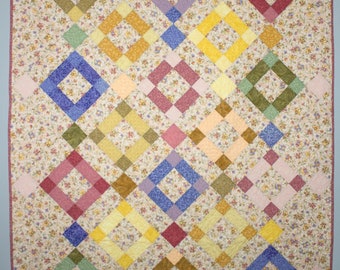 Contemporary Patchwork Throw Quilt in Multi-colored Pastels, Floral Background