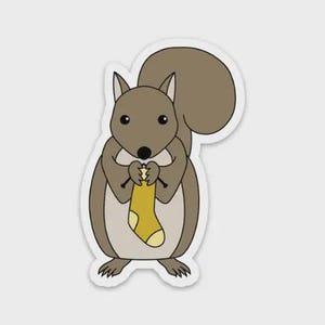 May include: A sticker featuring a cartoon squirrel knitting a yellow sock. The squirrel is brown and tan with a large fluffy tail. The sock has a yellow body with a white heel and toe. The sticker has a white border.
