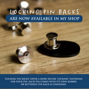 May include: Silver-colored metal locking pin backs with a cylindrical shape. The text LOCKING PIN BACKS ARE NOW AVAILABLE IN MY SHOP is displayed at the top, and additional text regarding pin fastening is at the bottom of the image.