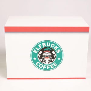 May include: A rectangular white box with a red border at the top and bottom edges. Centered on the front is a circular teal logo featuring a stylized figure wearing an elf hat, surrounded by the text ELFBUCKS COFFEE in white capital letters.