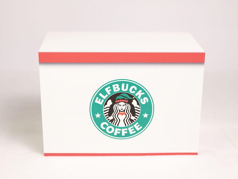 May include: A rectangular white box with a red border at the top and bottom edges. Centered on the front is a circular teal logo featuring a stylized figure wearing an elf hat, surrounded by the text ELFBUCKS COFFEE in white capital letters.