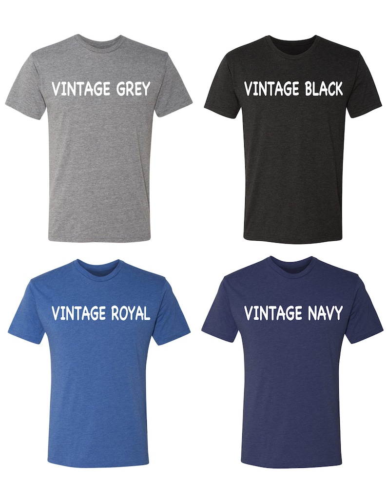 May include: Four t-shirts in different colors: vintage grey, vintage black, vintage royal, and vintage navy. Each shirt has the color name printed in white on the front.