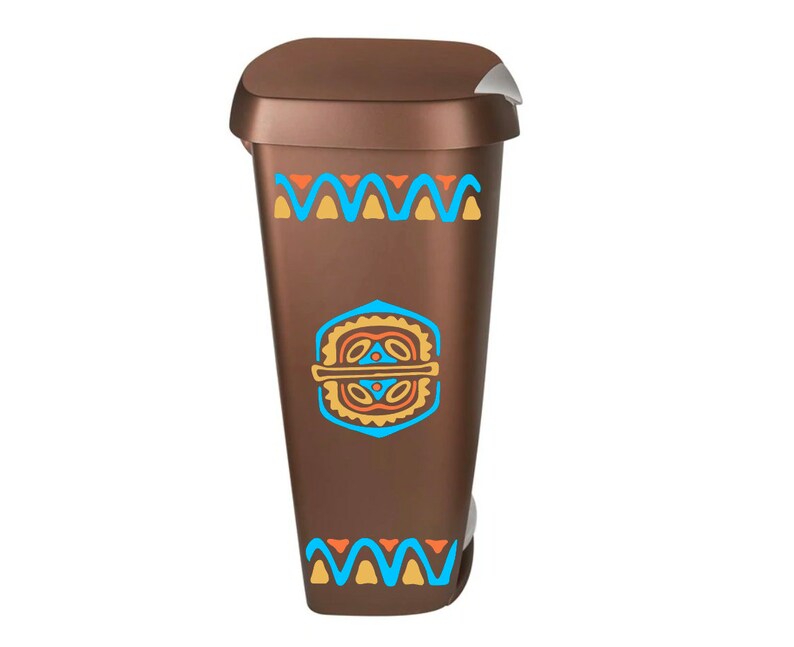 May include: A brown trash can with a geometric pattern in blue, orange, and yellow. The pattern features a repeating wave design and a central geometric shape.