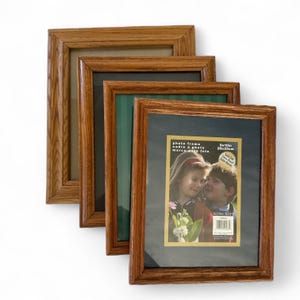 May include: Four wooden photo frames with a warm brown finish are arranged diagonally. The frames vary in the color of the backing, with one displaying a photo of two children. The frames are 8x10 inches (20x25 cm).