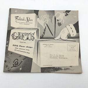 May include: Black and white illustration of a hand reaching into a box labeled "Gifts from our fifth floor shops". The text "Frederick & Nelson" is also visible on the image.