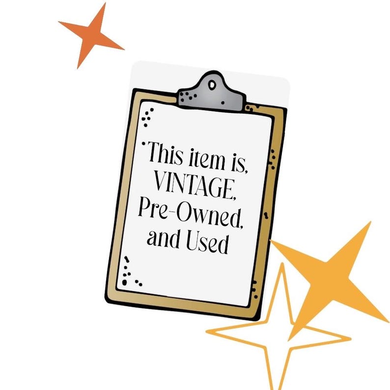 May include: A clipboard with a gold border and the text "This item is VINTAGE, Pre-Owned, and Used" in black. The clipboard has a silver clip at the top and is decorated with orange star shapes.