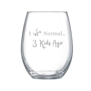 May include: A clear stemless wine glass with the text "I Was Normal... 3 Kids Ago" in a light gray color. The glass has a rounded shape and is designed for wine.