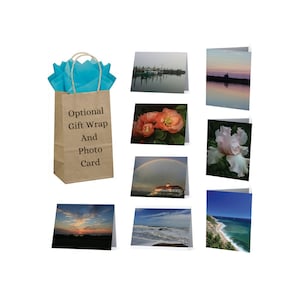May include: A brown paper gift bag with blue tissue paper inside. The bag has the text "Optional Gift Wrap And Photo Card" printed on it. The image also shows eight different photo cards with various images, including a sunset, a beach, a flower, and a lighthouse.