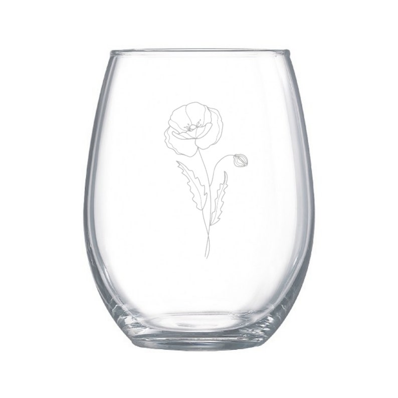 May include: A clear glass stemless wine glass with a delicate line drawing of a poppy flower etched on the side.