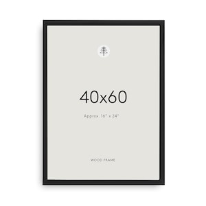 May include: A rectangular black wood frame with a light gray interior display area. The center features the text 40x60, followed by Approx. 16" x 24" and the word WOOD FRAME at the bottom. A small circular icon of a stylized tree is at the top.
