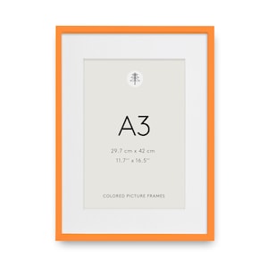 Pode incluir: Uma moldura retangular com uma borda laranja brilhante e um passe-partout branco. O centro exibe o texto A3, 29.7 cm x 42 cm, 11.7" x 16.5" e Colored Picture Frames, juntamente com um pequeno ícone de árvore na cor preta.