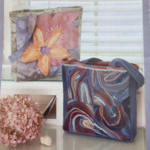 May include: A sewing pattern for a tote bag with a floral design and a swirling pattern. The pattern is titled "Two Times Two Tote" and is a Diane McCauley design. The pattern number is IJ754.