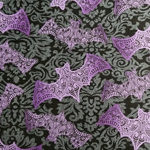 100% cotton Quilting fabric.  PRICED by the 1/2 yard and cut on order.  Spooky mottled purple filigree bats on black & grey background