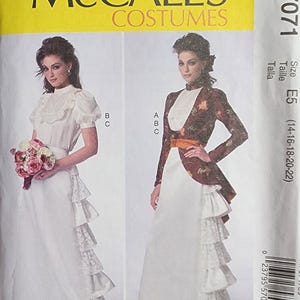May include: McCall's Costumes sewing pattern M7071. The pattern features two vintage costume designs. One design includes a white dress with a ruffled skirt and a white top. The other design includes a long white skirt, a floral jacket, and a high-collared top.