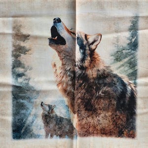 May include: A fabric panel featuring a printed illustration of two wolves in a forest setting. One large wolf is shown in profile with its head tilted upward, mouth open in a howl. A smaller wolf stands below, also looking upward. The colors are brown, gray, and white.