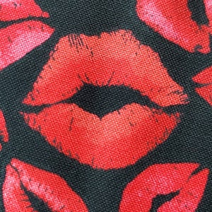 Bold black background with kissing kisses red lips, whimsical fun.  TT quilting fabric 100% cotton.   PRICED by 1/2 yard, cut on order.