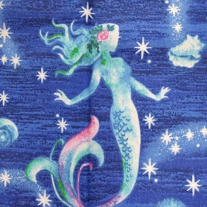 Mermaid mermaids blue ocean bubbles star fish sea shells. Priced by the 1/2 yard increments. 100% cotton Quilting fabric.