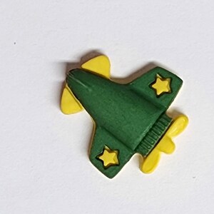 May include: Three green plastic toy airplanes with yellow details. Each plane has a star on the wing and a propeller.