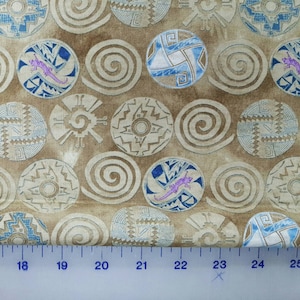 May include: A beige fabric with a repeating pattern of blue and brown geometric shapes. The shapes are stylized and resemble Native American pottery designs.